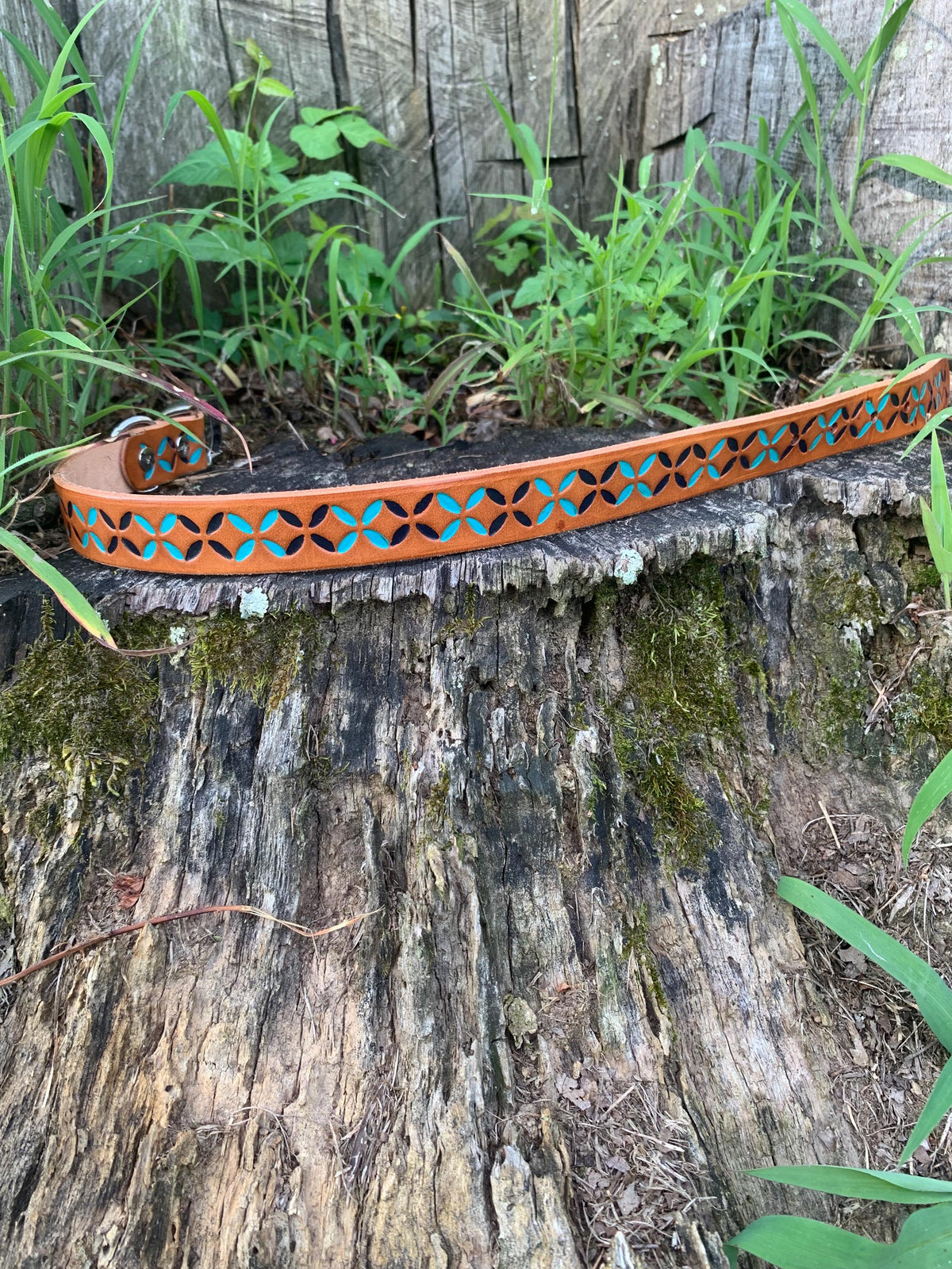 Colorful leather dog collar that is hand painted dark blue and teal.